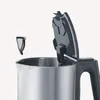 A close-up view of the top of a stainless steel electric kettle with its lid open, showing a removable filter. Produktbild-Vorschau