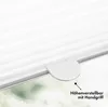 Close-up of a white pleated blind mechanism with a handle, set against a blurred green and white background. Produktbild-Vorschau