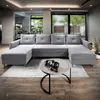 A modern living room with a large U-shaped sofa and a coffee table. Produktbild-Vorschau
