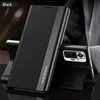 A black flip phone case is shown standing upright, with a smartphone inserted into it, displaying the phone's rear camera module. The case has a textured finish and a reflective strip with text. Produktbild-Vorschau