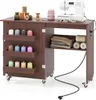 A sewing table with a sewing machine and various sewing supplies. Anteprima dell’immagine prodotto