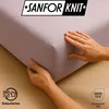 Hands are shown adjusting a fitted sheet on a mattress, with a logo and certification marks visible. Produktbild-Vorschau