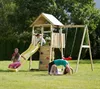 Children playing on a wooden playground set with a slide, climbing wall, and swing. Podgląd zdjęcia produktu