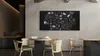 A dining area with a large blackboard on the wall, displaying a chalk drawing of various food items and ingredients. Produktbild-Vorschau