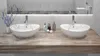 A bathroom vanity with two sinks and faucets. Náhled obrázku produktu