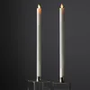 Two LED candles with a flickering flame sit in metallic candle holders against a dark background. Podgląd zdjęcia produktu