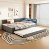 A corner daybed with a pull-out trundle bed is set up in a bedroom with decorative wall art and a bookshelf in the background. Anteprima dell’immagine prodotto