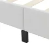 A close-up of a white bed frame with a black support leg. Náhled obrázku produktu