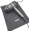 A black hairdryer with rose gold accents rests on a black fabric pouch, both on a white background. Podgląd zdjęcia produktu