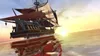 A majestic sailing ship with red sails glides across a calm sea during a vibrant sunset. Produktbild-Vorschau