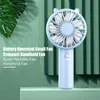 A light blue handheld fan with a cute bear-ear design is placed on a light green surface, with green leaves and a green striped background. Text describing the product's features is overlaid on the left side of the image. Produktbild-Vorschau