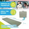 A folded mattress is shown next to a car with a family and a dog inside, suggesting travel suitability. Produktbild-Vorschau