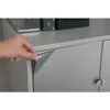 A hand peeling a silver metallic self-adhesive film from a cabinet door. Produktbild-Vorschau