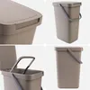 A collage of four images showing different views of a brown plastic trash can with a lid and handle. Produktbild-Vorschau