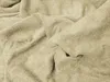A close-up view of a crumpled beige terry cloth fabric. Náhľad obrázku produktu
