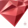 A close-up of a red 3D wall panel with a geometric, faceted design. Produktbild-Vorschau