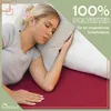A woman sleeping on a bed with a pillow. Produktbild-Vorschau