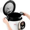 A person's hands are shown holding the inner pot of a white and gold multicooker with its lid open. Produktbild-Vorschau