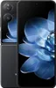 A black foldable smartphone with a blue floral wallpaper displayed on the screen. Náhled obrázku produktu