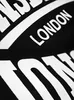 A close-up of text on a black fabric. Produktbild-Vorschau