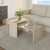 A living room scene with a sofa, a cabinet, and a nesting coffee table set. Produktbild-Vorschau