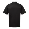 A plain studio shot of a black short-sleeved chef's jacket, viewed from the back. Voir les images du produit