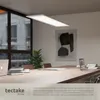 A modern office meeting room with a long wooden table, chairs, laptops, and a hanging LED panel light. Produktbild-Vorschau