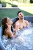 A couple relaxing in a hot tub outdoors. Náhled obrázku produktu