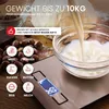 A digital kitchen scale with various ingredients and a bowl of milk being poured into it, set against a rustic background. Produktbild-Vorschau