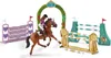A toy horse and rider jumping over obstacles, set up for a show jumping competition. Anteprima dell’immagine prodotto