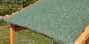 A close-up view of the green, textured roof of a wooden bird aviary. Produktbild-Vorschau