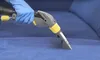 A gloved hand is using a cleaning tool on a blue upholstered surface. Náhľad obrázku produktu