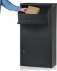 A person is placing a package into a dark gray parcel mailbox. Produktbild-Vorschau