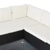 Close-up view of a section of a black rattan outdoor sofa with white cushions. Produktbild-Vorschau