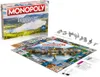 A Monopoly board game set with its box and accessories, displayed on a white background. Produktbild-Vorschau