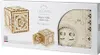 The image shows the packaging of a UGEARS 3D-Puzzle Safe model. The box displays images of the assembled puzzle and its components, along with branding and product information. Produktbild-Vorschau
