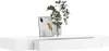 A white floating shelf with a drawer, displaying a framed abstract artwork and a vase with greenery. Produktbild-Vorschau