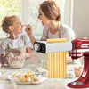 A mother and daughter are in a kitchen, making pasta. Produktbild-Vorschau