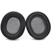Two black headphone ear pads with gray fabric inserts are shown against a white background. Náhled obrázku produktu