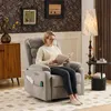 A woman is sitting in a recliner chair reading a book. The room is decorated with wallpaper and a floor lamp. Náhľad obrázku produktu