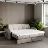 A sofa bed with a mattress topper laid out on it, in a modern living room setting. Produktbild-Vorschau