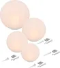 Four illuminated spherical lights of varying sizes are arranged in a group, with accompanying accessories like remote controls and stakes visible. Produktbild-Vorschau