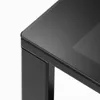 A close-up view of the corner of a black table with a glass top. Produktbild-Vorschau