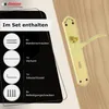 A gold door handle set is shown on a wooden door, with a black overlay detailing the contents of the set. Produktbild-Vorschau