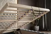 Close-up view of the wooden slatted base of a bed, showing the lifting mechanism and straps. Náhľad obrázku produktu