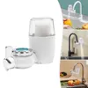 A collage of images showing a water filter attached to different kitchen faucets, with one image showing a hand rinsing fruit under filtered water. Produktbild-Vorschau
