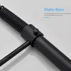 Close-up of a matte black kitchen faucet component with a coiled hose and a knob. Náhled obrázku produktu