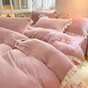 A close-up view of a pink bedding set with ruffled edges, neatly arranged on a bed. Produktbild-Vorschau