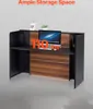 A reception desk with a computer and decorative items on it. Anteprima dell’immagine prodotto