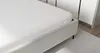 A white mattress on a bed frame. Produktbild-Vorschau